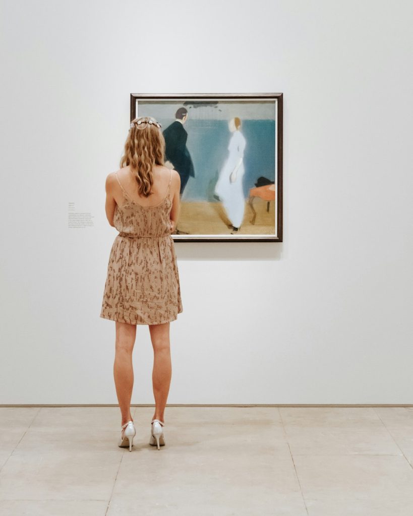 a-woman-looking-at-a-painting-in-a-museum-45xjpxtfeym Woman pondering a painting in a prestigious summer art exhibition
