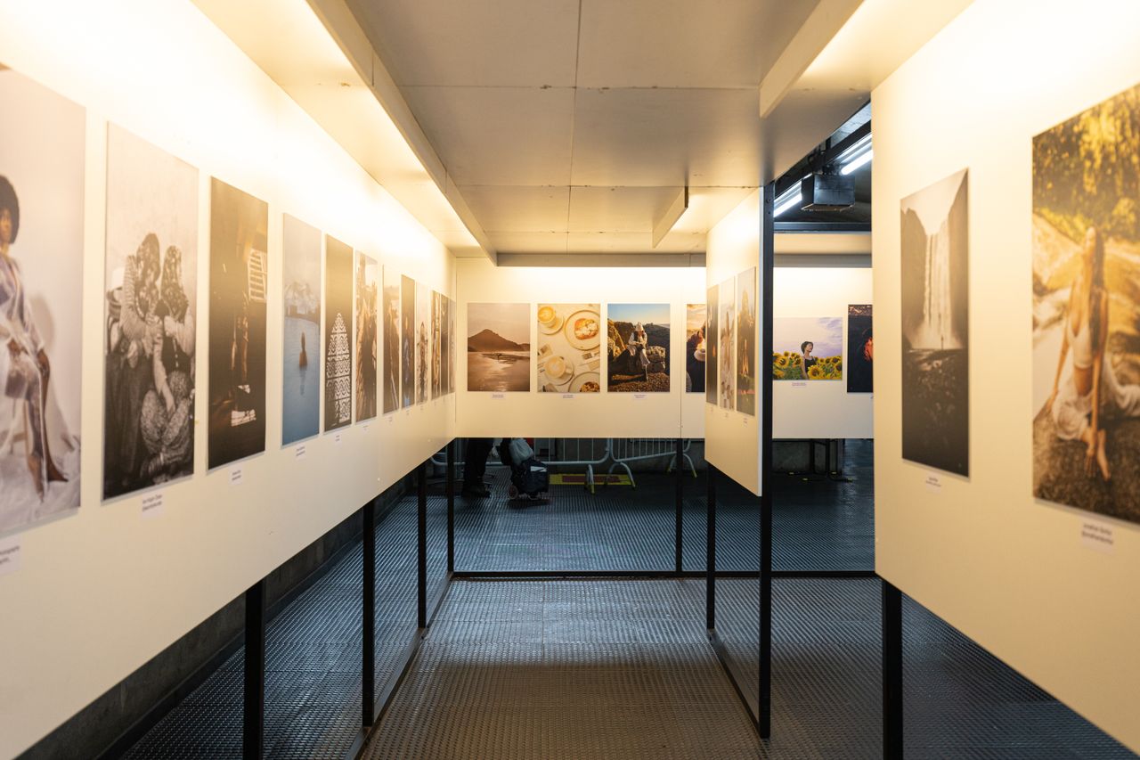 Crafting Captivating Headlines: Your awesome post title goes here A well-lit art exhibition featuring diverse photographic prints in a modern indoor gallery.
